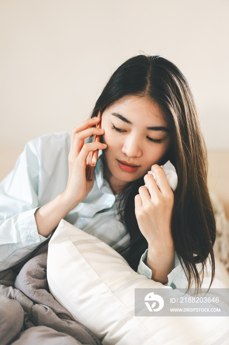 Young adult lonely single woman using smartphone in the moring for telemedicine and mental health