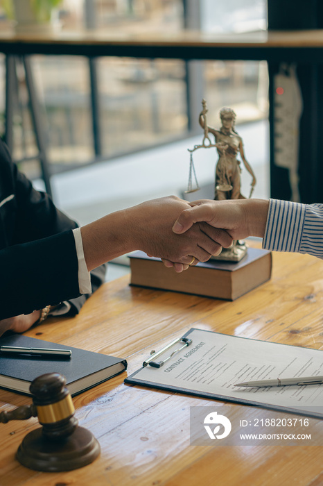 Lawyers shake hands with businessmen to make a deal. legal advisor Various contract consulting services to plan court proceedings with scales and hammers placed beside