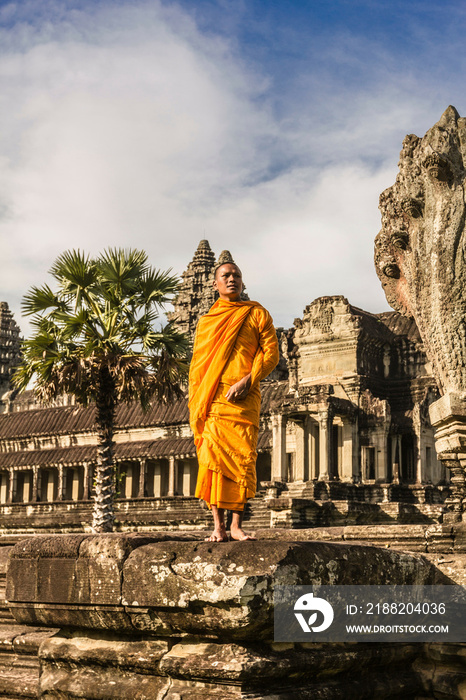 Young Buddhist monk standing outside temple in Angkor Wat, Siem Reap, Cambodia