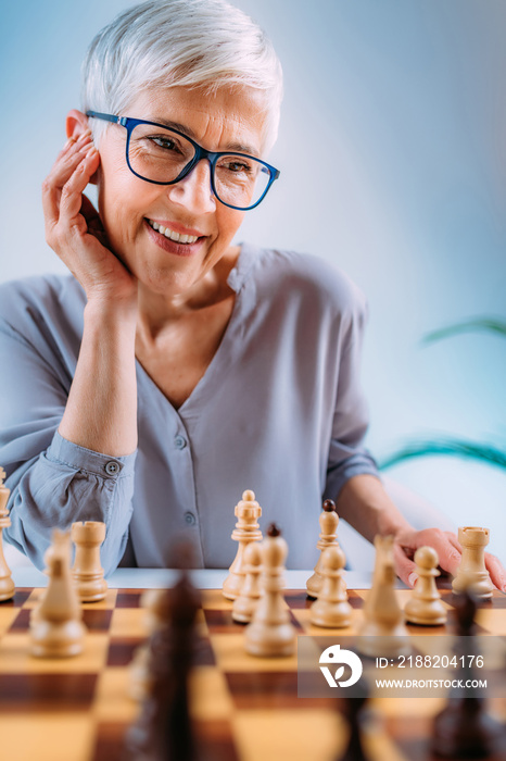 Cognitive Rehabilitation Activity. Senior Woman Playing Chess.