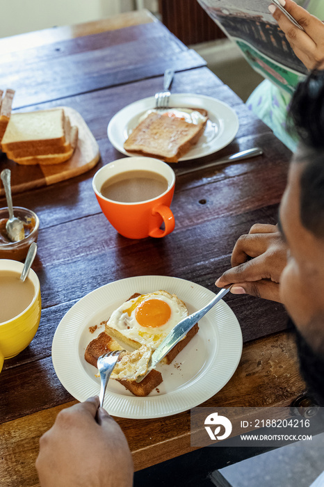 Couple making breakfast together at home in the morning