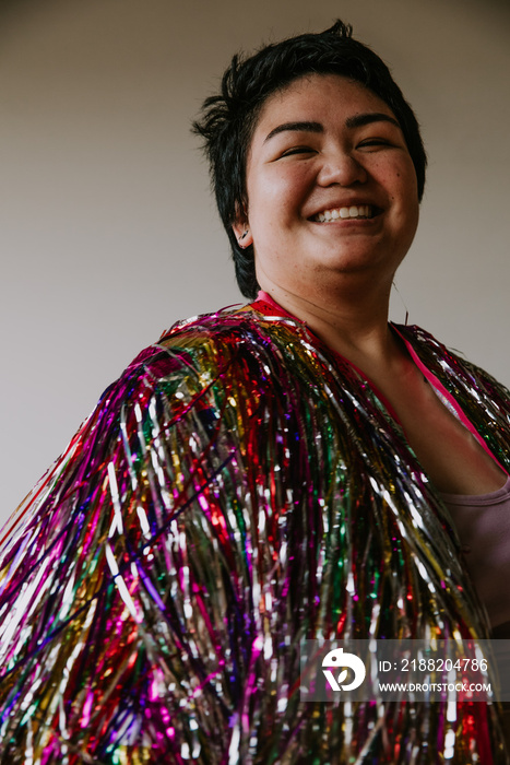 closeup of a plus size filipino woman wearing a tinsel jacket smiling