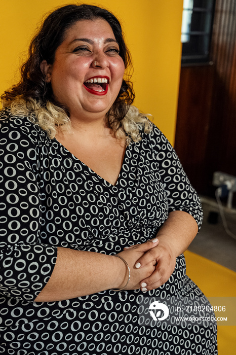 Plus sized female getting her headshots taken by a south asian female photographer