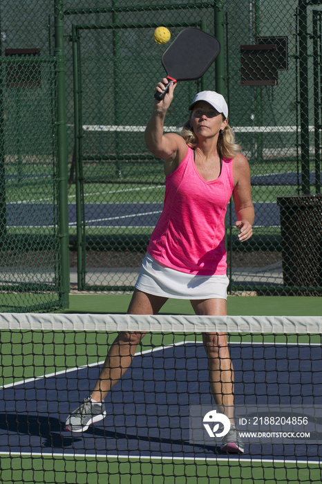 Pickleball Action - Attractive Senior Woman Hitting Ball