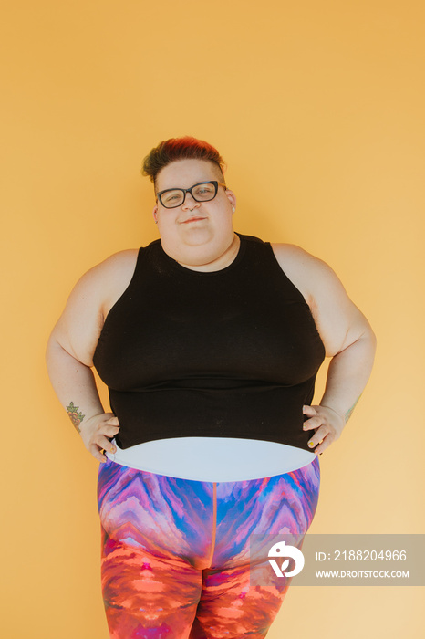 portrait of a plus size person with hands on hips