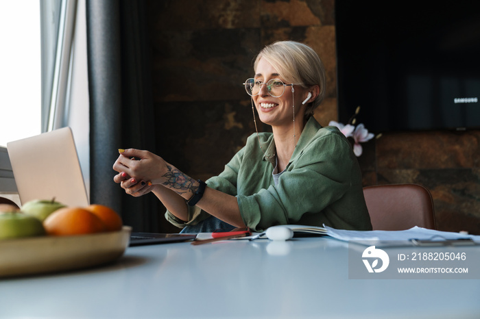 Middle aged blonde woman with short hair studying