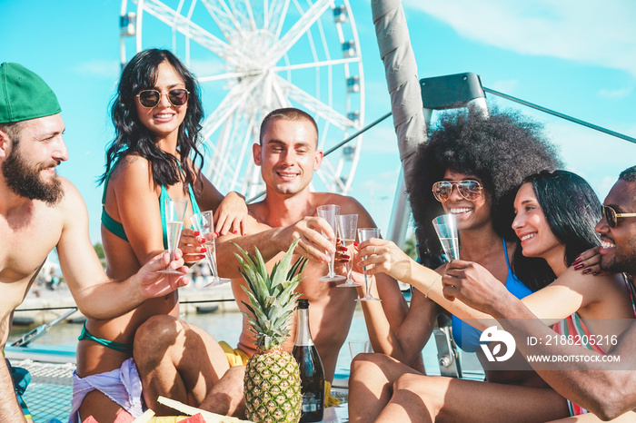 Happy friends drinking champagne in summer boat party - Young people having fun celebrating and cheering - Youth lifestyle, exclusive fest and vacation concept - Main focus on hands glasses