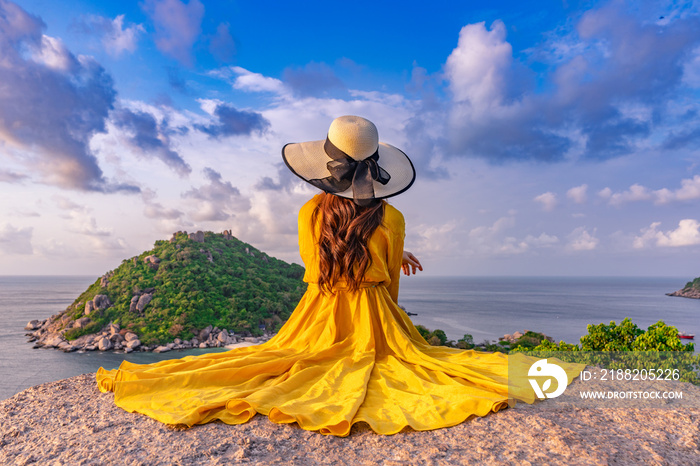 Asian female tourist sitting at the viewpoint on  Koh Nang Yuan island, Thailand.