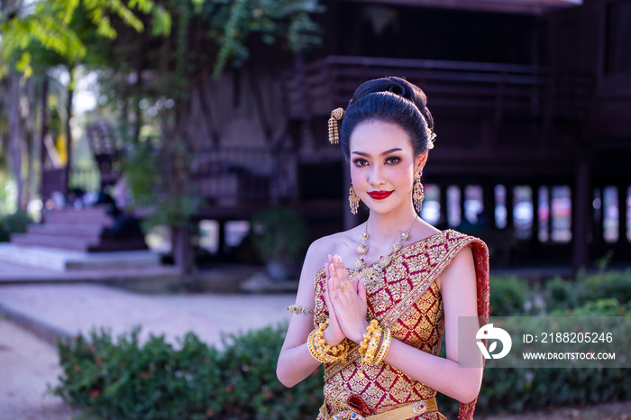 Smiling Woman In Traditional Clothing Looking Away While Standing Against Building