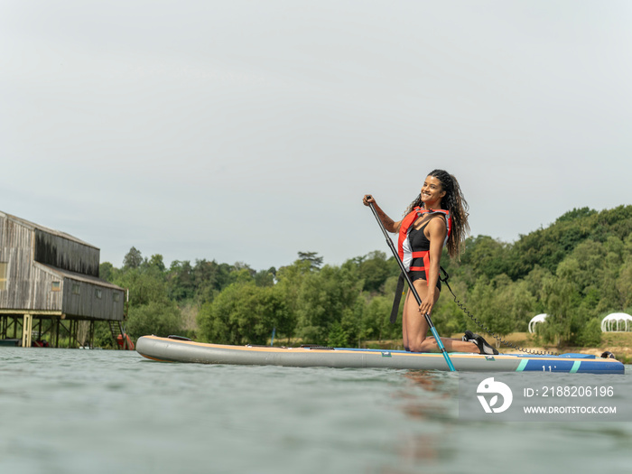 Woman paddleboarding on lake