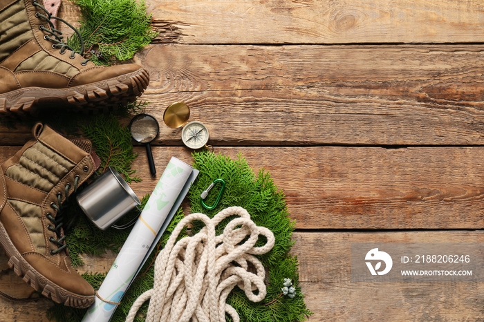 Items and shoes for hiking on wooden background