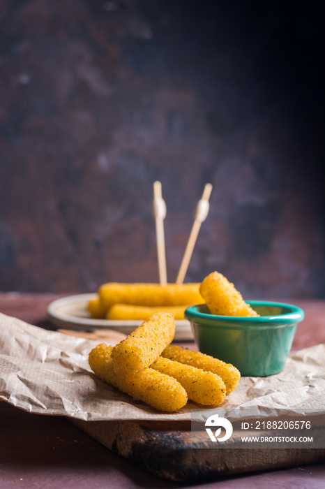 Mozzarella sticks coated with hot sauce.