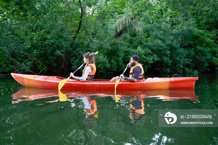 people on kayak outing rafting down the river