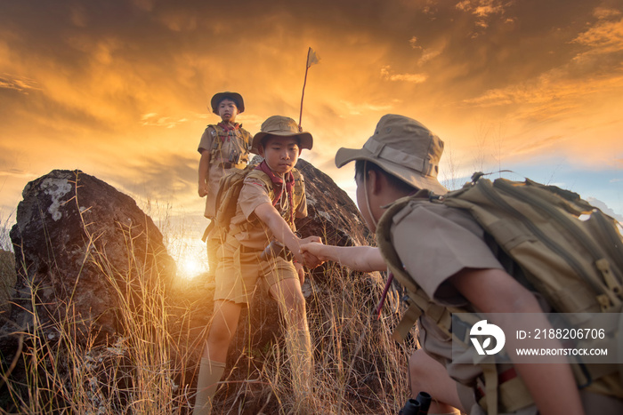 Scouts work as a team. Help each other pull up from the cliff.