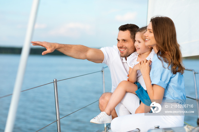 Parents And Daughter Hugging Standing On Boat Deck Looking Aside