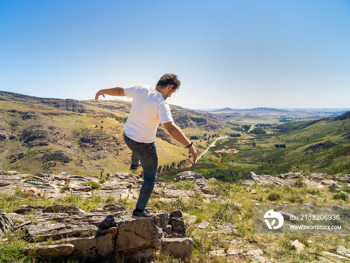 Young hiker falling down backwards at Cerro Bahía Blanca