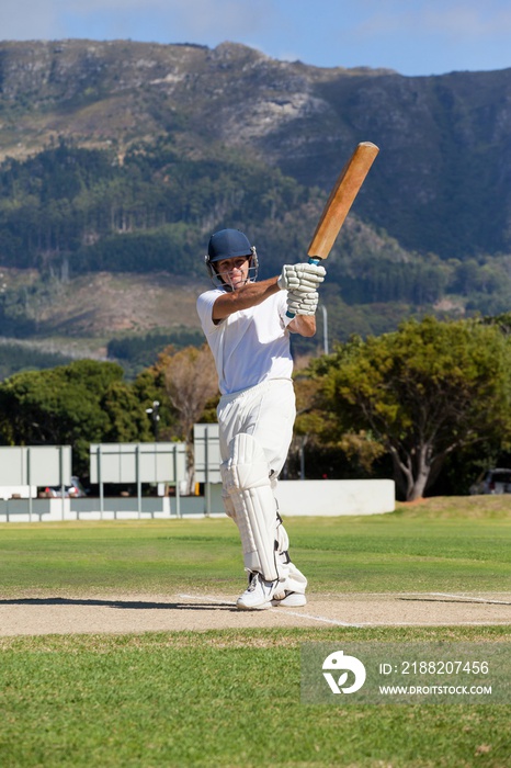 Full length of batsman playing cricket on field