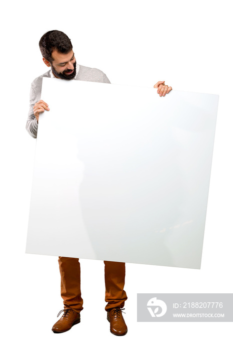 Handsome man with beard holding an empty placard