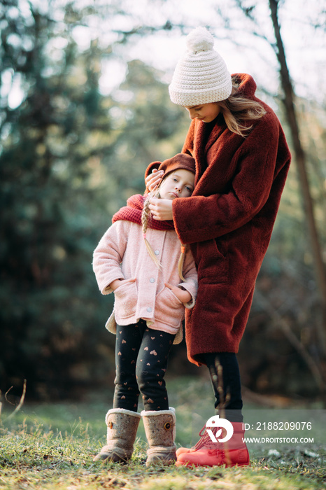 Mother and daughter are in the forest.