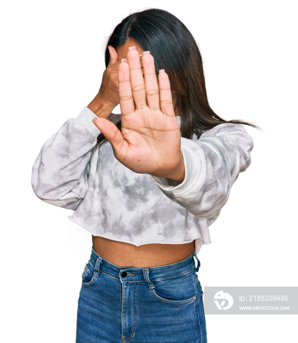 Young latin transsexual transgender woman wearing casual clothes covering eyes with hands and doing stop gesture with sad and fear expression. embarrassed and negative concept.