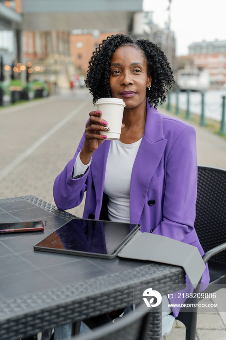 Portrait of woman using digital tablet during coffee break in cafe