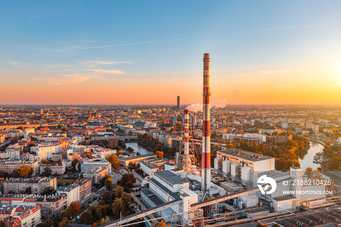 City CHP, power plant with smoking chimneys against the background of the city, aerial photography. Air pollution concept from factories