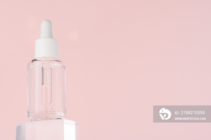 Hyaluronic acid oil, serum with collagen and peptides skin care product on transparent acrylic cube. Cosmetic liquid mockup in transparent bottle. Mock up packaging, cosmetics design branding