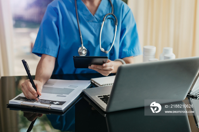 Medical technology concept. Doctor working with mobile phone and stethoscope and digital tablet laptop in modern office at hospital