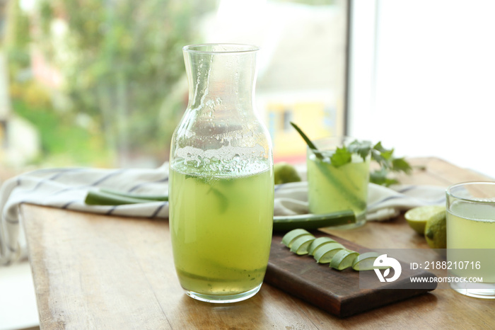 Jug of aloe vera cocktail on wooden table