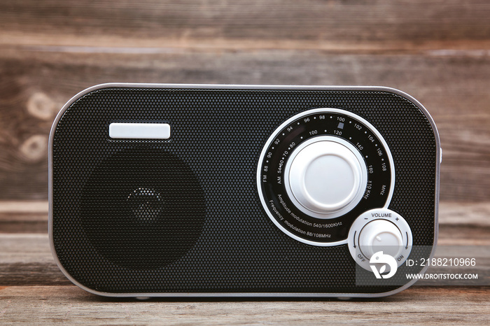 Stylish compact radio on a wooden background