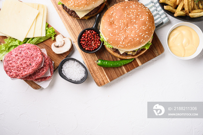 Burger with ingredients on white textured background with space for text