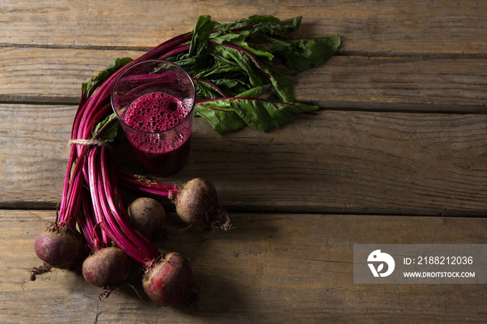 Beetroot and beetroot juice on wooden table