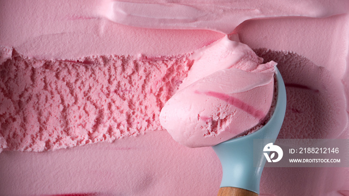 Ice cream Strawberry scooped out from container with a spoon, Closeup Top view Food concept.