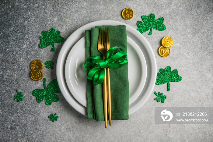 Beautiful festive table setting for St.Patricks day with cutlery and lucky symbols. Copy spase in center. Flat lay.