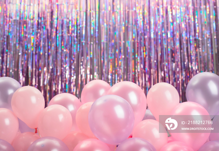 Pink and purple balloons on colorful background.