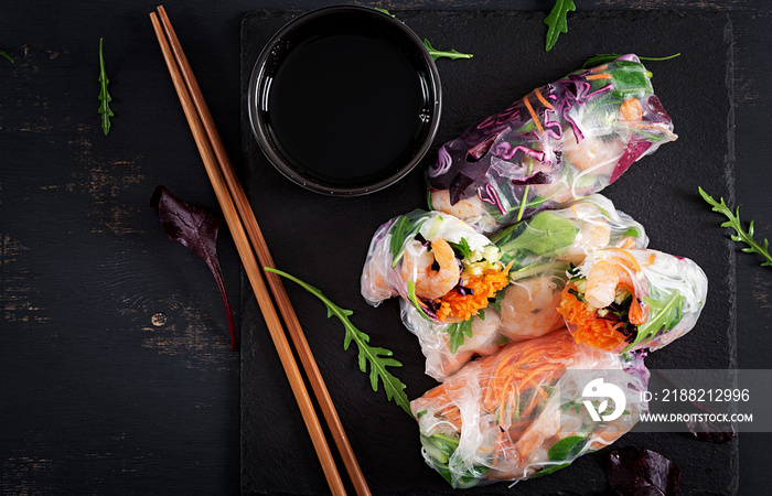 Vegetarian vietnamese spring rolls with spicy shrimps, prawns,  carrot, cucumber, red cabbage and rice noodle. Seafood. Tasty meal.  Top view, flat lay, copy space