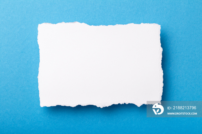 piece of white paper with torn edges on a colored background with a place for text