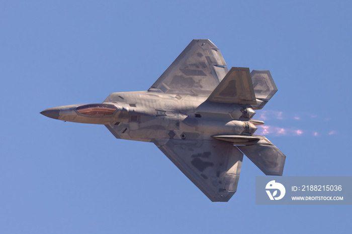 F-22 Raptor in a turn in beautiful light ,  with afterburners on