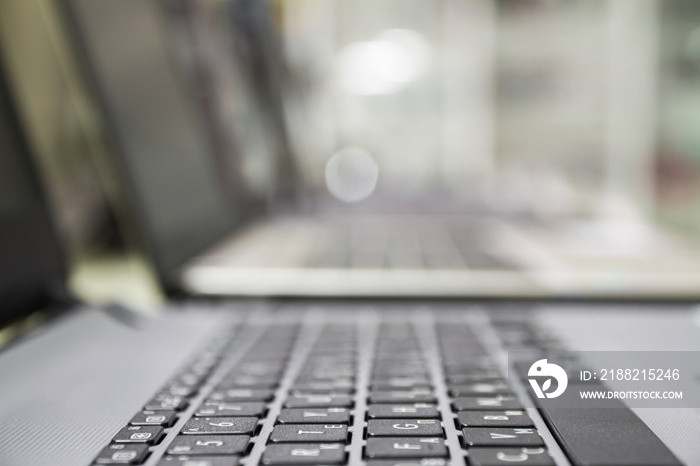 A row of laptops in computer shop. Closeup, selective focus