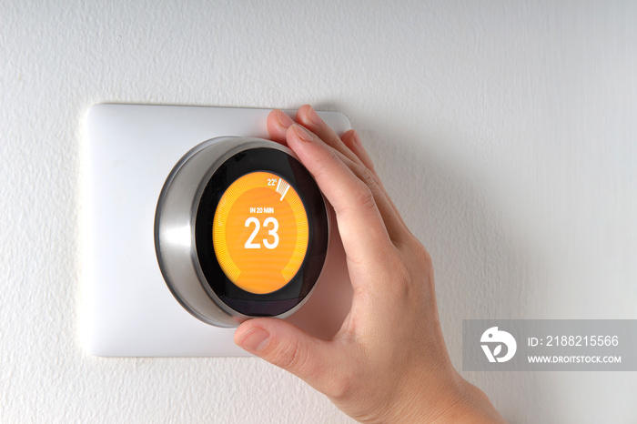 Smart Thermostat with a hand setting up the temperature