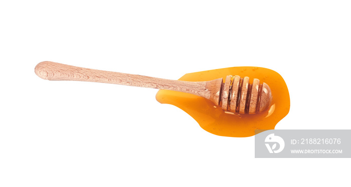 honey dripping from a wooden dipper