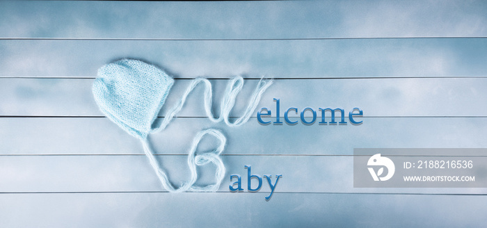 Welcome baby boy on wood background. Baby shower, birthday, invitation or greeting card idea. Newborn concept.  Copy space.