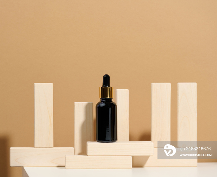 brown glass bottle with pipette stands on a white table. Cosmetics SPA branding. Packaging for gel, serum, advertising and product promotion