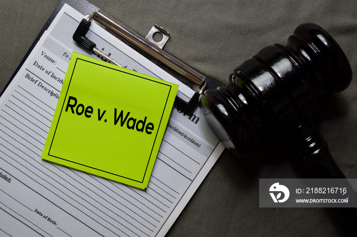 Roe v. Wade on sticky notes and gavel isolated on office desk. Law concept