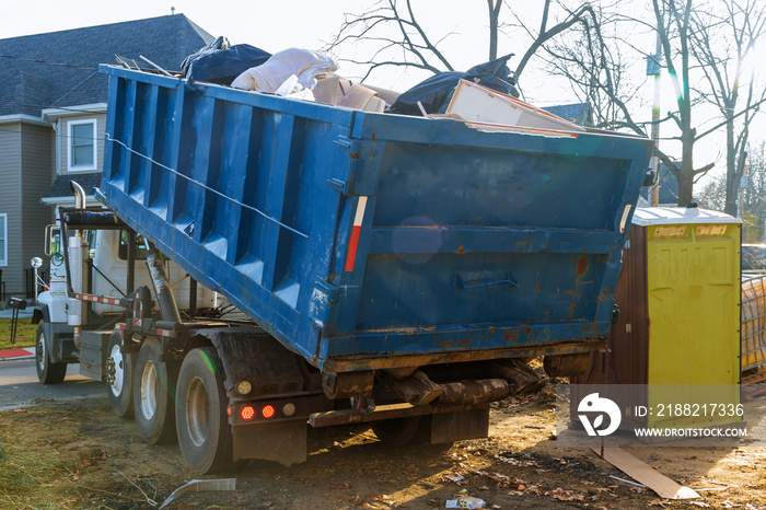 Removal of debris construction waste building demolition with rock and concrete rubble on portable bio-toilets