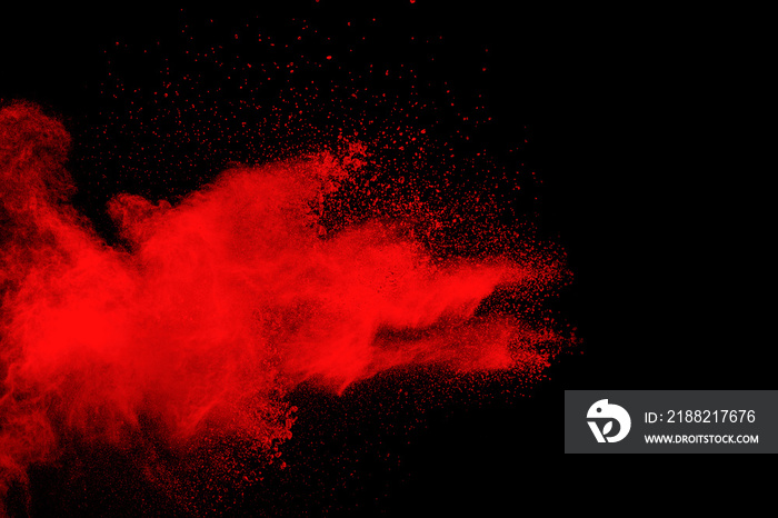 Red color powder explosion on black background.Freeze motion of red dust particles splashing.