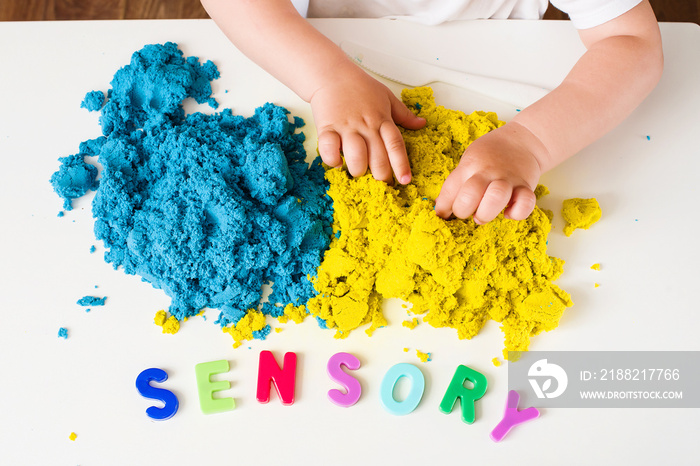 Sensory word and magic kinetic sand. Early sensory education. Kidd’s sensory experiences, games and play for fine motor skills. Therapy hand, development of fine motor, autism, occupational therapy