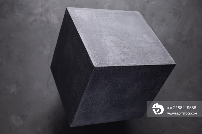 Concrete cube shape on floor background texture. Cement block as abstract concept