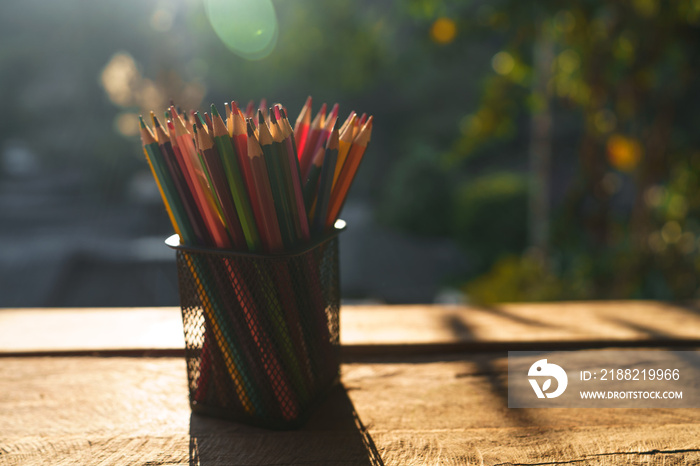 Colored pencils on the desk that are working outside the house nature light