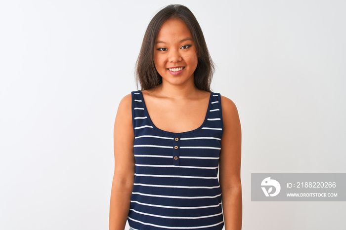 Young chinese woman wearing striped t-shirt standing over isolated white background with a happy and cool smile on face. Lucky person.